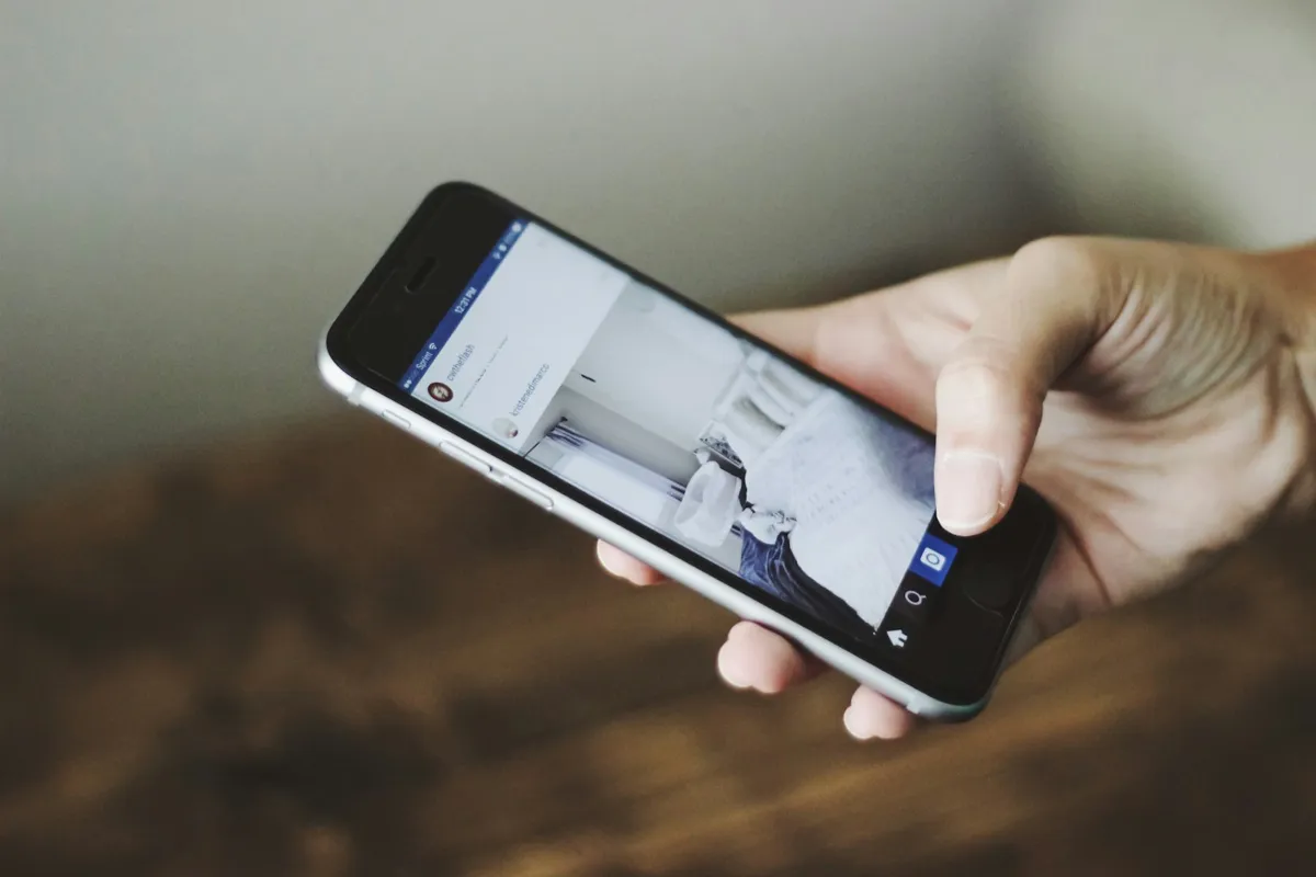 Hand holding a phone with an app open